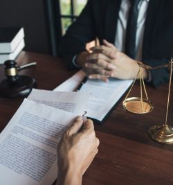 An image capturing a Pomona employment lawyer diligently working on a case. | United Employees Law Group